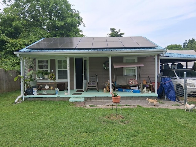 450 Old Sevierville Hwy, Newport, TN 37821 - rear view of house featuring a porch, roof mounted solar panels, and a metal roof