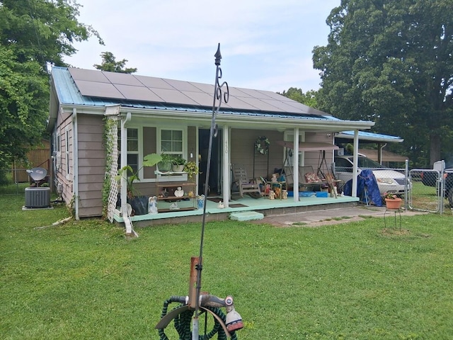 450 Old Sevierville Hwy, Newport, TN 37821 - back of property featuring roof mounted solar panels, covered porch, a metal roof, and a gate
