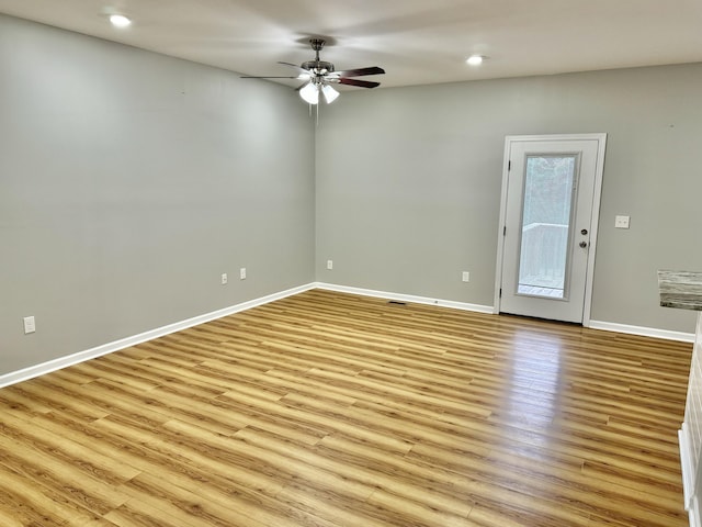 empty room featuring ceiling fan and light wood-type flooring
