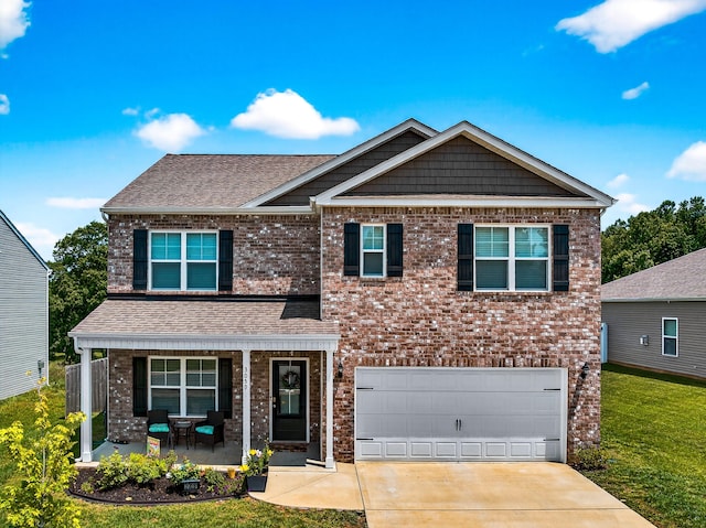 3059 Berna Way, Morristown, TN 37814 - view of front of home featuring covered porch, brick siding, driveway, a garage, and a front yard