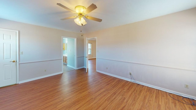 spare room featuring hardwood / wood-style flooring and ceiling fan