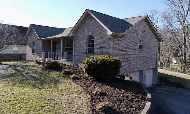 view of property exterior featuring a yard, a garage, and a porch