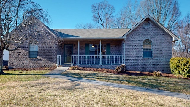 ranch-style house featuring a front lawn and covered porch