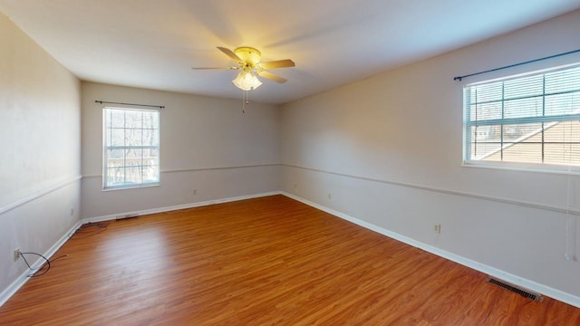 spare room with wood-type flooring and ceiling fan