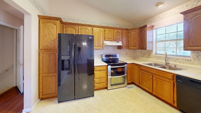 kitchen with lofted ceiling, sink, and black appliances