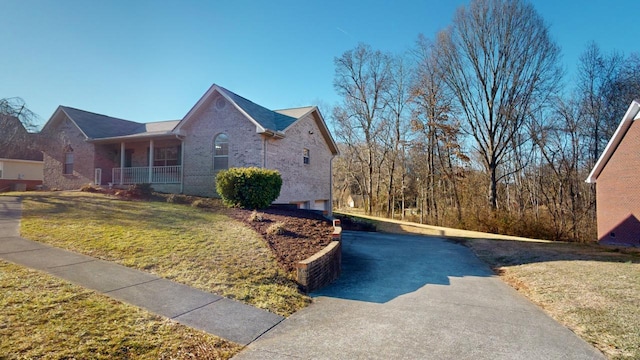 view of home's exterior with a porch and a lawn