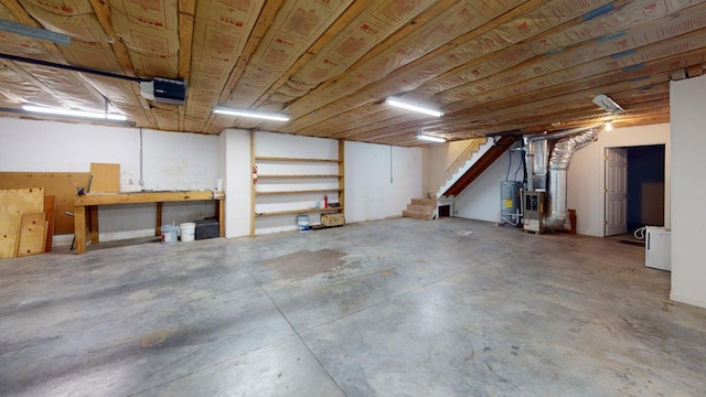 basement featuring electric water heater and heating unit