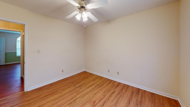 spare room with ceiling fan and light wood-type flooring