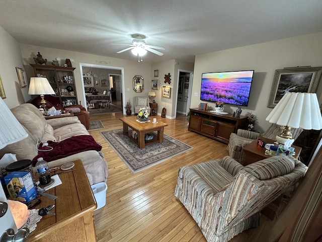 living room featuring ceiling fan and light wood-style flooring