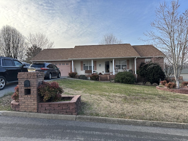 ranch-style home featuring brick siding, a front lawn, roof with shingles, covered porch, and an attached garage