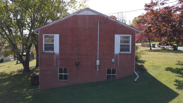 view of side of home with a lawn