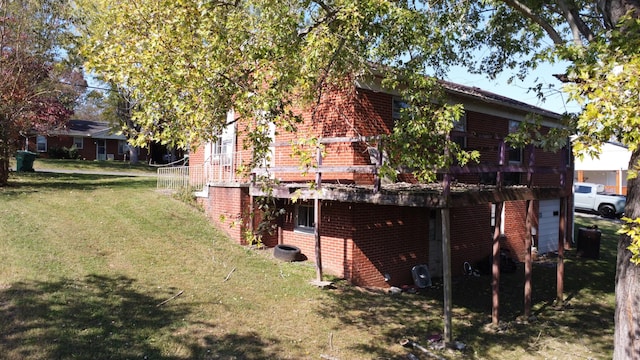 rear view of house featuring a deck and a yard