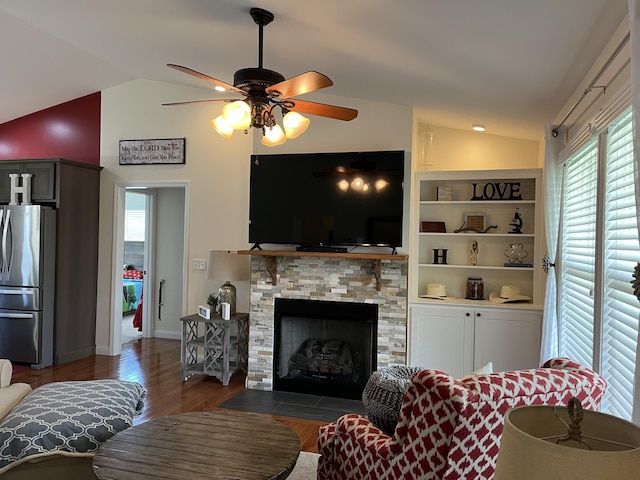 122 Florence Cir, Dandridge, TN 37725 - living area featuring lofted ceiling, plenty of natural light, wood finished floors, a ceiling fan, and a stone fireplace