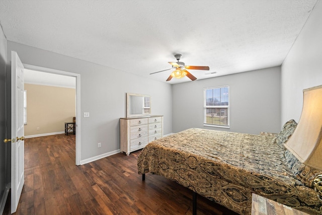 bedroom with dark wood-type flooring, ceiling fan, a textured ceiling, and baseboards