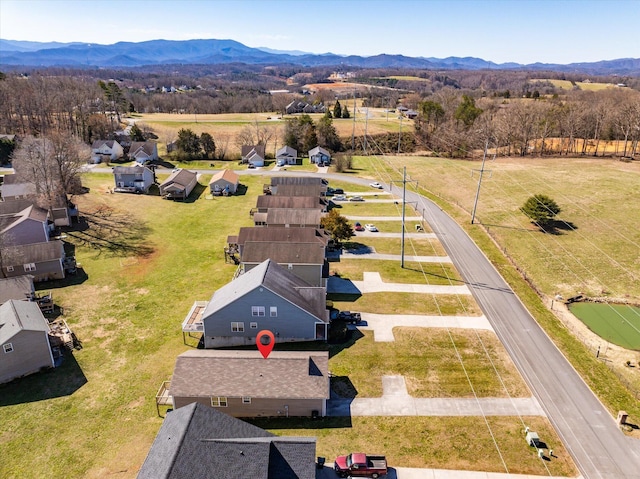 birds eye view of property with a mountain view