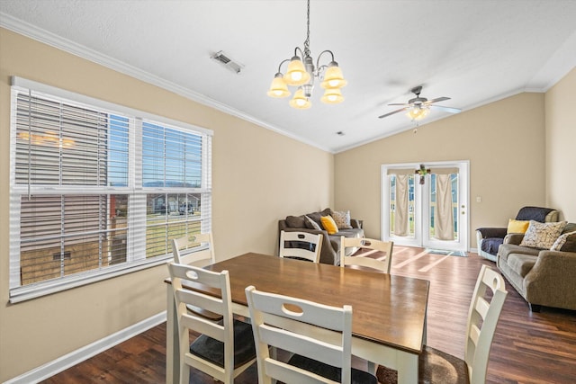 dining room featuring crown molding, lofted ceiling, visible vents, wood finished floors, and baseboards