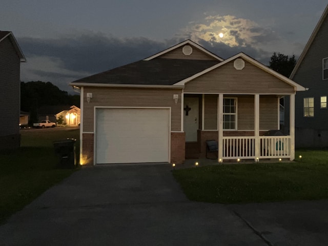 view of front of home with covered porch, a front yard, a garage, cooling unit, and driveway