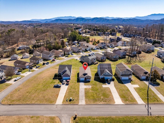 drone / aerial view featuring a residential view and a mountain view