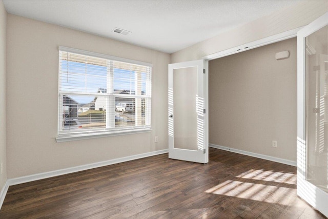 unfurnished bedroom with dark wood-type flooring