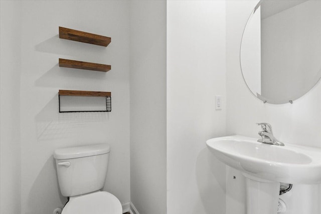 bathroom featuring sink and toilet