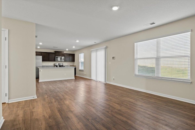 unfurnished living room with dark hardwood / wood-style floors