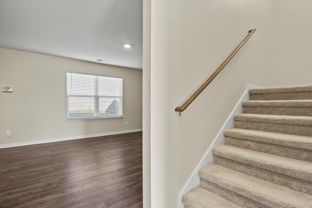staircase featuring wood-type flooring