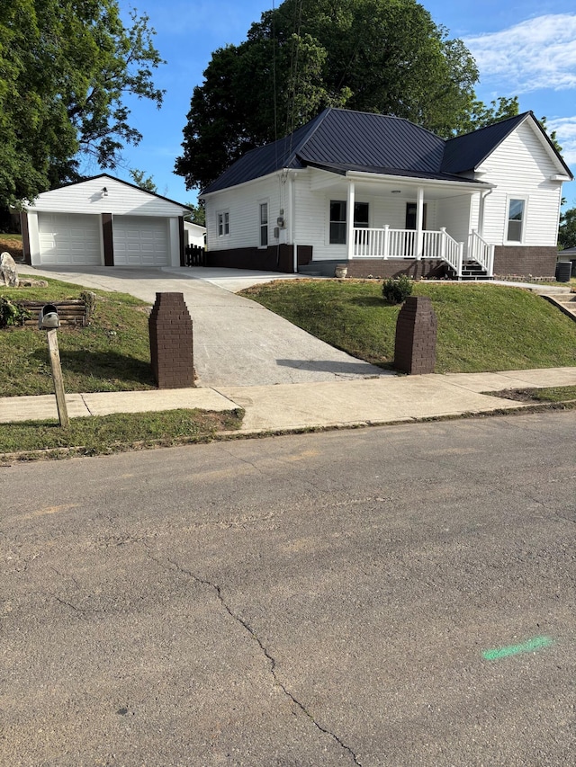 219 Inman St, Morristown, TN 37813 - ranch-style house with an outbuilding, covered porch, a garage, concrete driveway, and a front yard