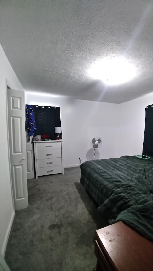 carpeted bedroom with a textured ceiling