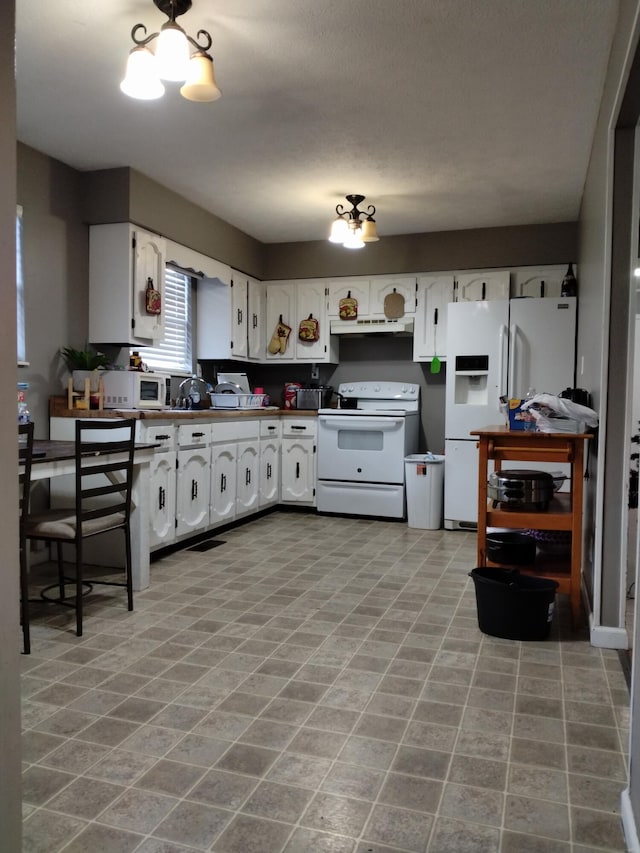 kitchen featuring white cabinetry, range hood, and white appliances