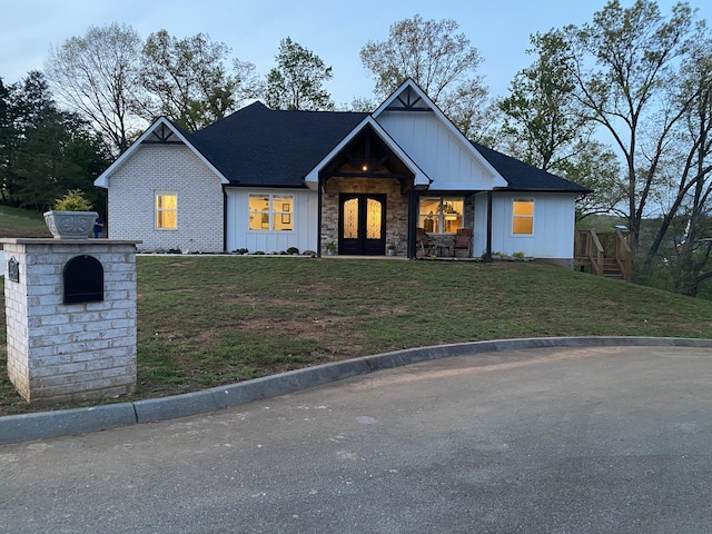 323 Eagle Claw Ln, Dandridge, TN 37725 - view of front of home featuring board and batten siding, a front yard, and french doors
