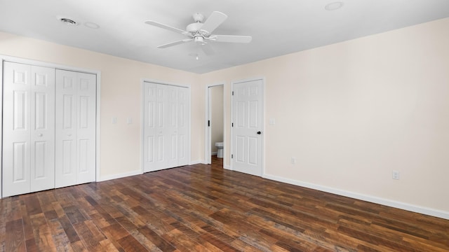 1302 Chestnut St, Kingsport, TN 37664 - unfurnished bedroom featuring multiple closets, wood finished floors, baseboards, and a ceiling fan