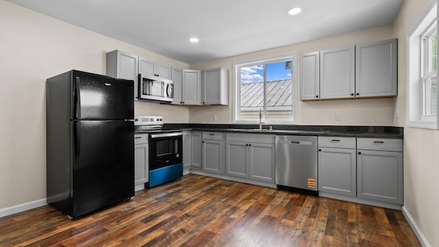 1302 Chestnut St, Kingsport, TN 37664 - kitchen with stainless steel appliances, dark countertops, gray cabinets, a sink, and recessed lighting