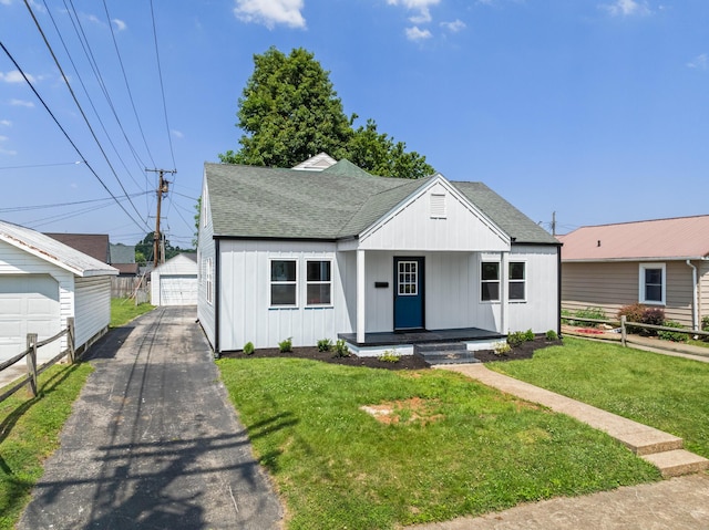 1302 Chestnut St, Kingsport, TN 37664 - bungalow-style home featuring a shingled roof, board and batten siding, a detached garage, covered porch, and an outdoor structure