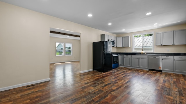 1302 Chestnut St, Kingsport, TN 37664 - kitchen featuring stainless steel appliances, dark countertops, gray cabinets, healthy amount of natural light, and recessed lighting