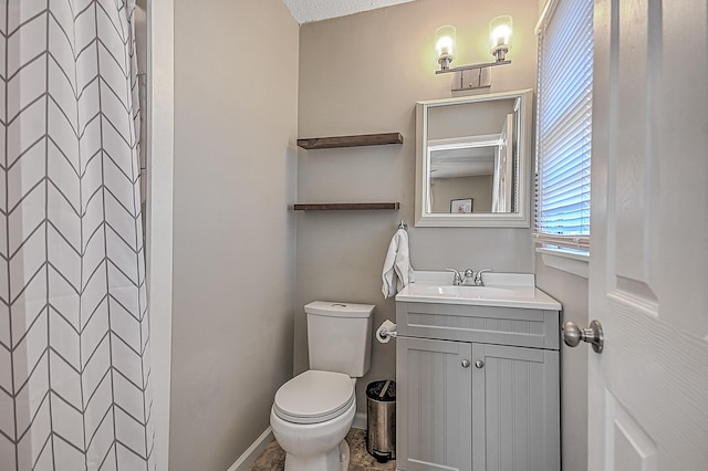 bathroom with vanity, a shower, and toilet