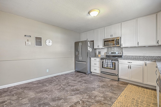 kitchen with tasteful backsplash, appliances with stainless steel finishes, a textured ceiling, and white cabinets