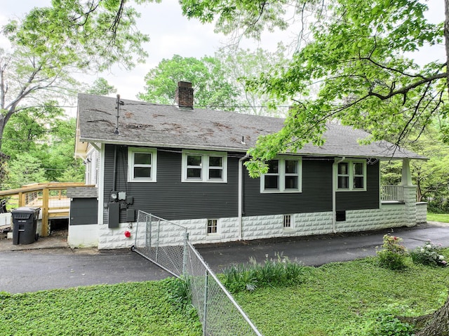 rear view of house featuring a chimney
