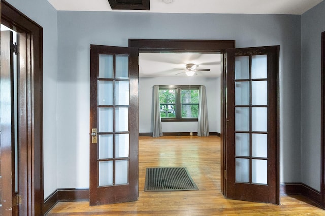 doorway to outside with visible vents, wood finished floors, baseboards, ceiling fan, and french doors