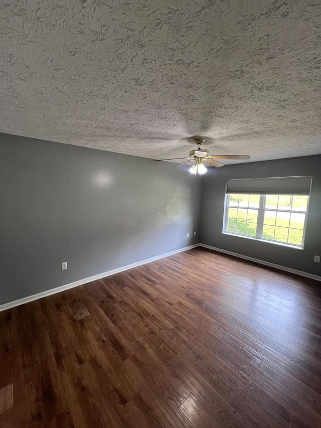 575 Paw Paw Way, Newport, TN 37821 - unfurnished room with ceiling fan, a textured ceiling, baseboards, and dark wood-style floors