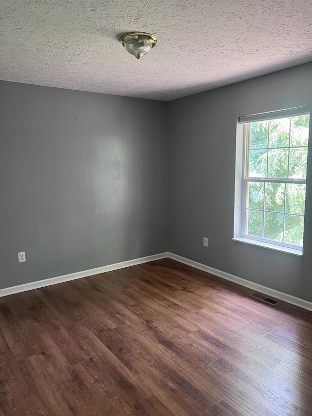 575 Paw Paw Way, Newport, TN 37821 - spare room with dark wood-style floors, a textured ceiling, and baseboards