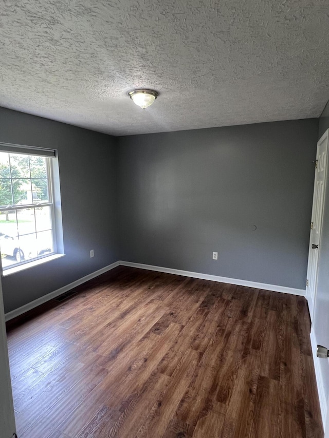 575 Paw Paw Way, Newport, TN 37821 - unfurnished room featuring dark wood-type flooring, baseboards, and a textured ceiling