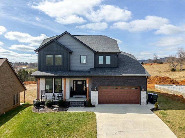 view of front of house with board and batten siding, a front yard, a porch, and concrete driveway