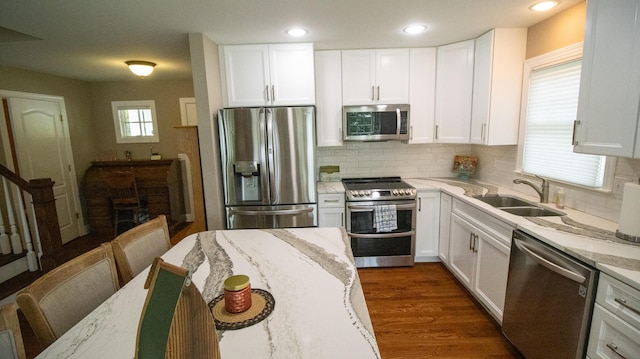 976 Bridgeview Hills Dr, Dandridge, TN 37725 - kitchen with stainless steel appliances, light stone counters, decorative backsplash, white cabinets, and recessed lighting