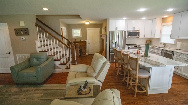 976 Bridgeview Hills Dr, Dandridge, TN 37725 - kitchen featuring appliances with stainless steel finishes, open floor plan, a kitchen bar, white cabinetry, and recessed lighting