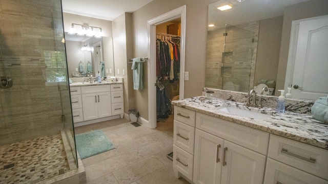 976 Bridgeview Hills Dr, Dandridge, TN 37725 - bathroom featuring a shower stall, two vanities, a walk in closet, and tile patterned flooring