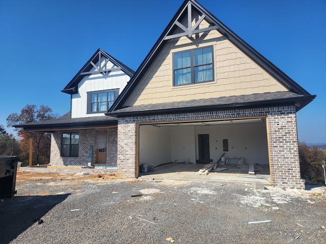 view of front of home featuring a garage and a patio