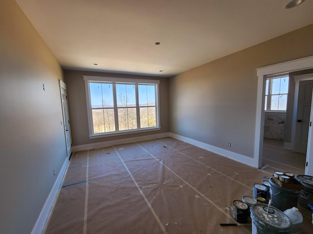 unfurnished room featuring baseboards
