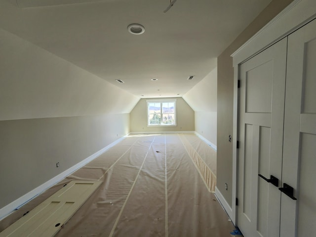 bonus room featuring lofted ceiling and baseboards