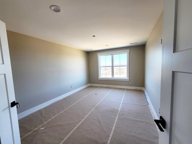 spare room featuring visible vents and baseboards