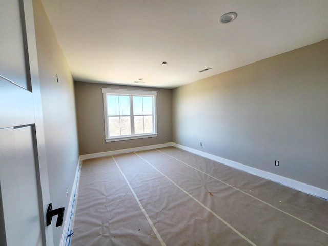 spare room with visible vents and baseboards